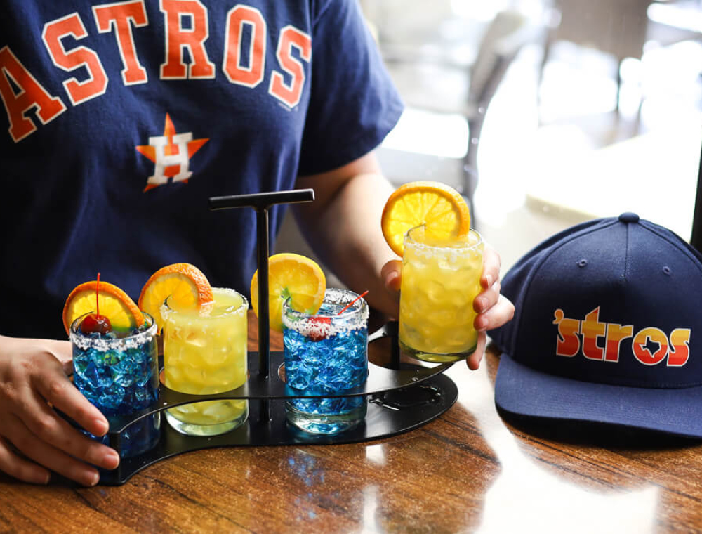 this blue and orange margarita flight features two of our Azul margaritas made with Silver Tequila and Blue Curacao, and two Cadillac margaritas made with Silver Tequila and Grand Marnier.