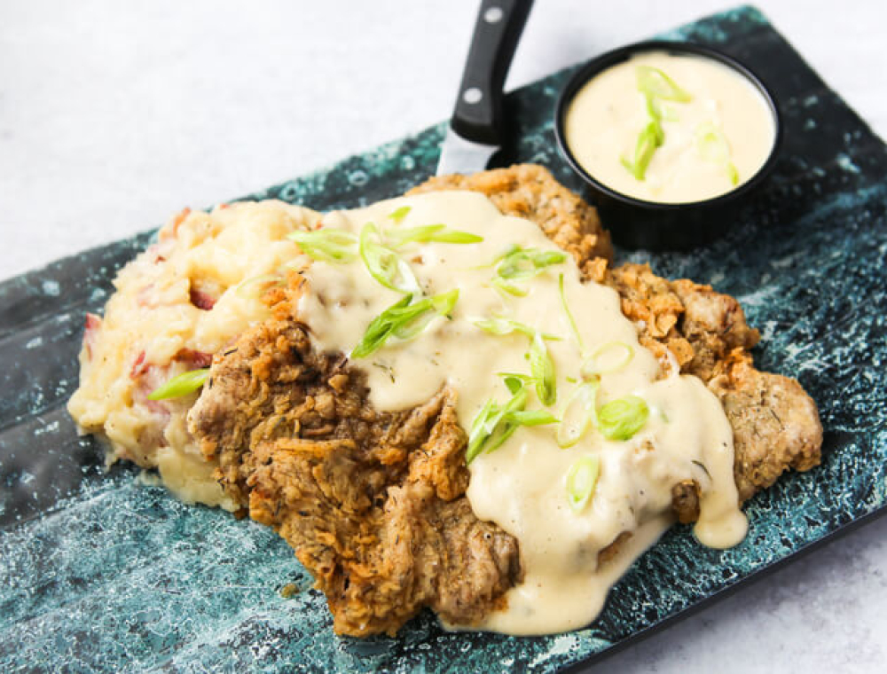 8 oz. Snake River Farms cutlet, roasted garlic mashed potatoes, scallions, house-made cream gravy