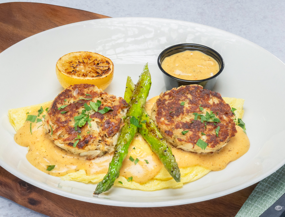 House-made crab cakes, citrus Cajun hollandaise sauce, asparagus, charred lemon