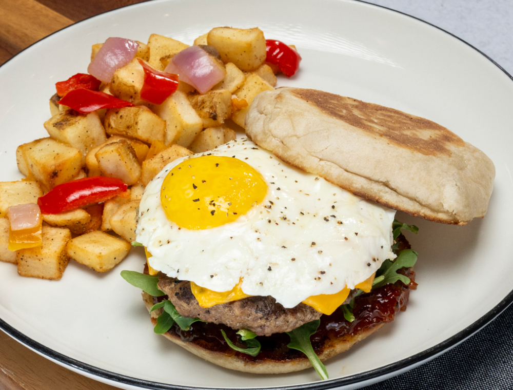 Beef patty, American cheese, sunny side egg, arugula, spicy bacon jam, English muffin, house potatoes
