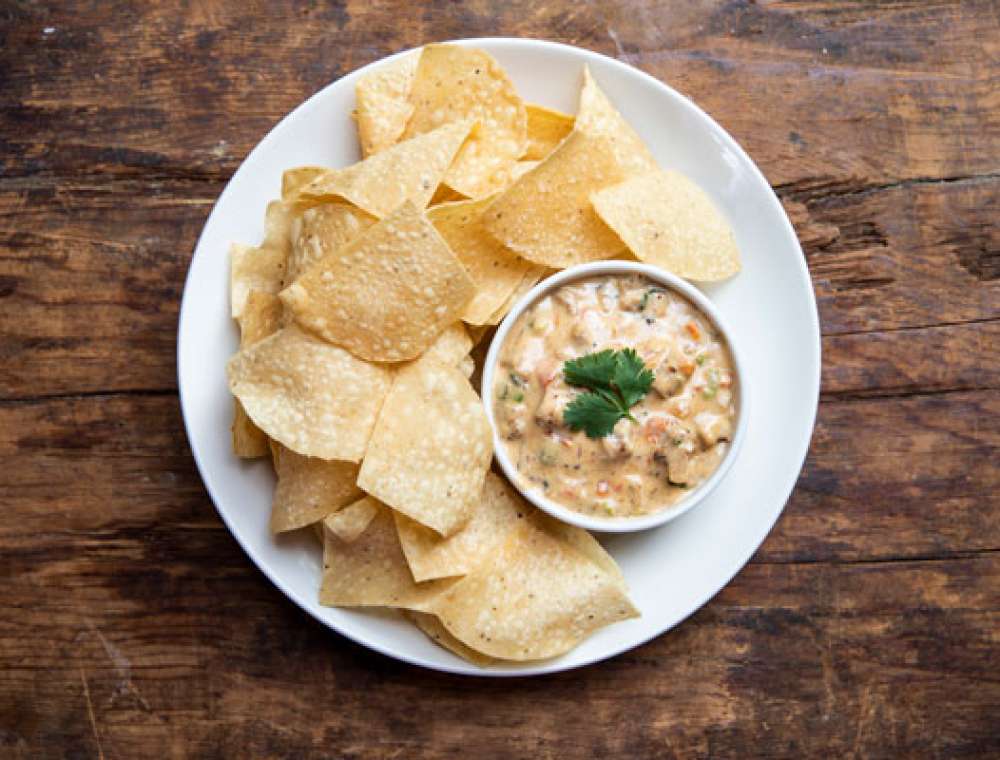 If you want a pre-flight snack, try our new Cockpit Queso: house-made queso, roasted peppers and onions, tomatoes, spicy sausage, cilantro and corn tortilla chips.