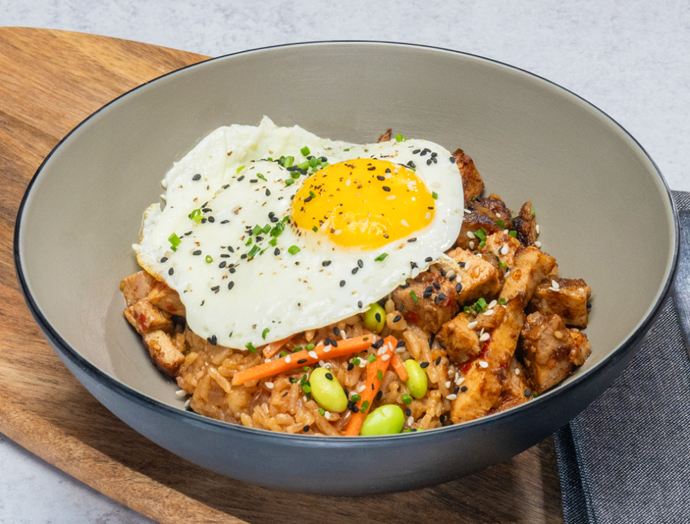 Roasted pork belly, sesame soy garlic rice, carrots, edamame, chili crisp, fried egg, sesame seeds, chive