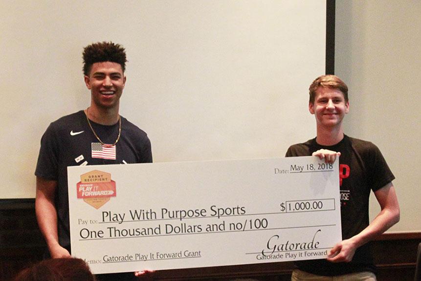 Quentin Grimes is presented with a giant check during Play With Purpose’s Youth In Leadership event at Black Walnut