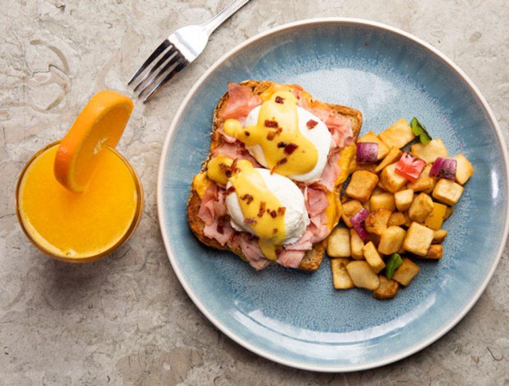 Two extra-large poached eggs, wheatberry toast, hardwood smoked ham, American cheese, spicy mustard sauce, cayenne citrus hollandaise