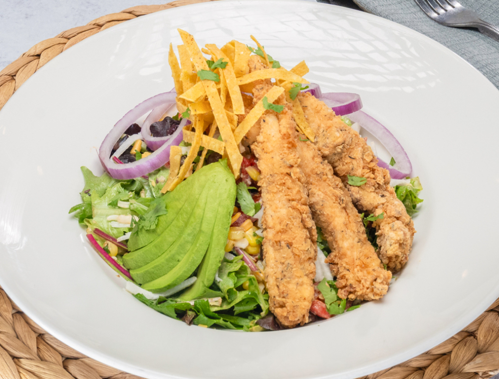 Crispy chicken tenders, red onions, roasted corn salsa, black beans, roasted red bell pepper, cheddar, mozzarella, jicama, avocado, tortilla strips, cilantro, spring mix, Southwest dressing