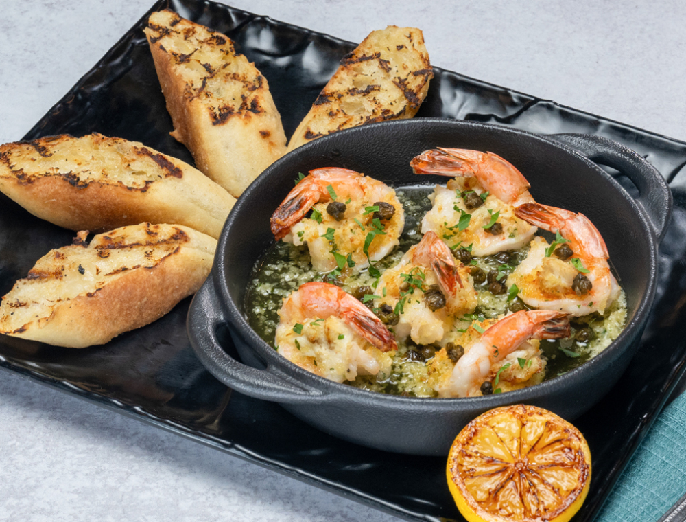 Six tail-on crab-topped shrimp, white wine garlic butter, breadcrumbs, capers, charred lemon, served with grilled artisan bread